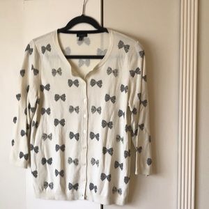 Sweet soft cream cardigan with bow details.